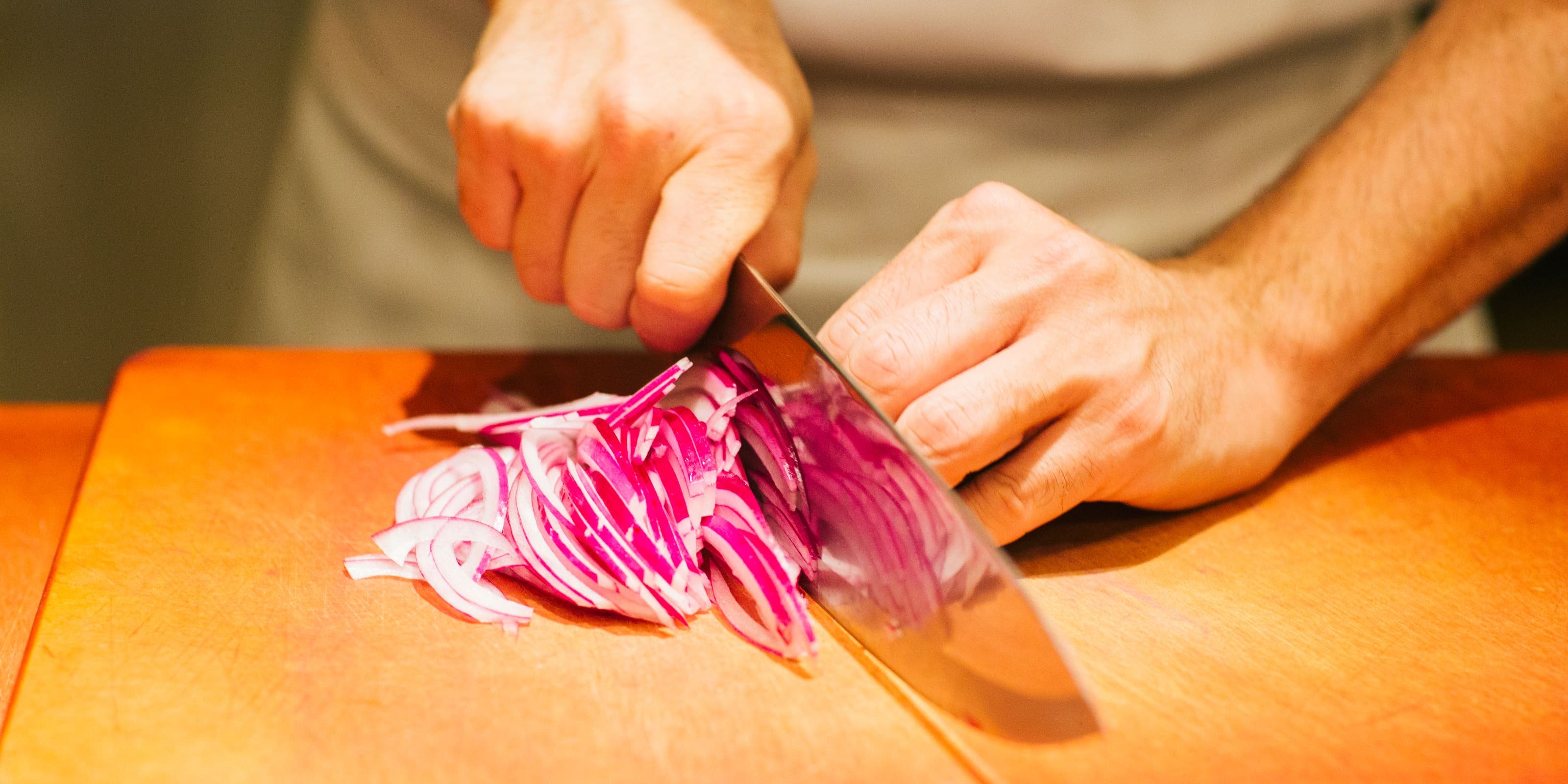 Bazille chef cutting onions.
