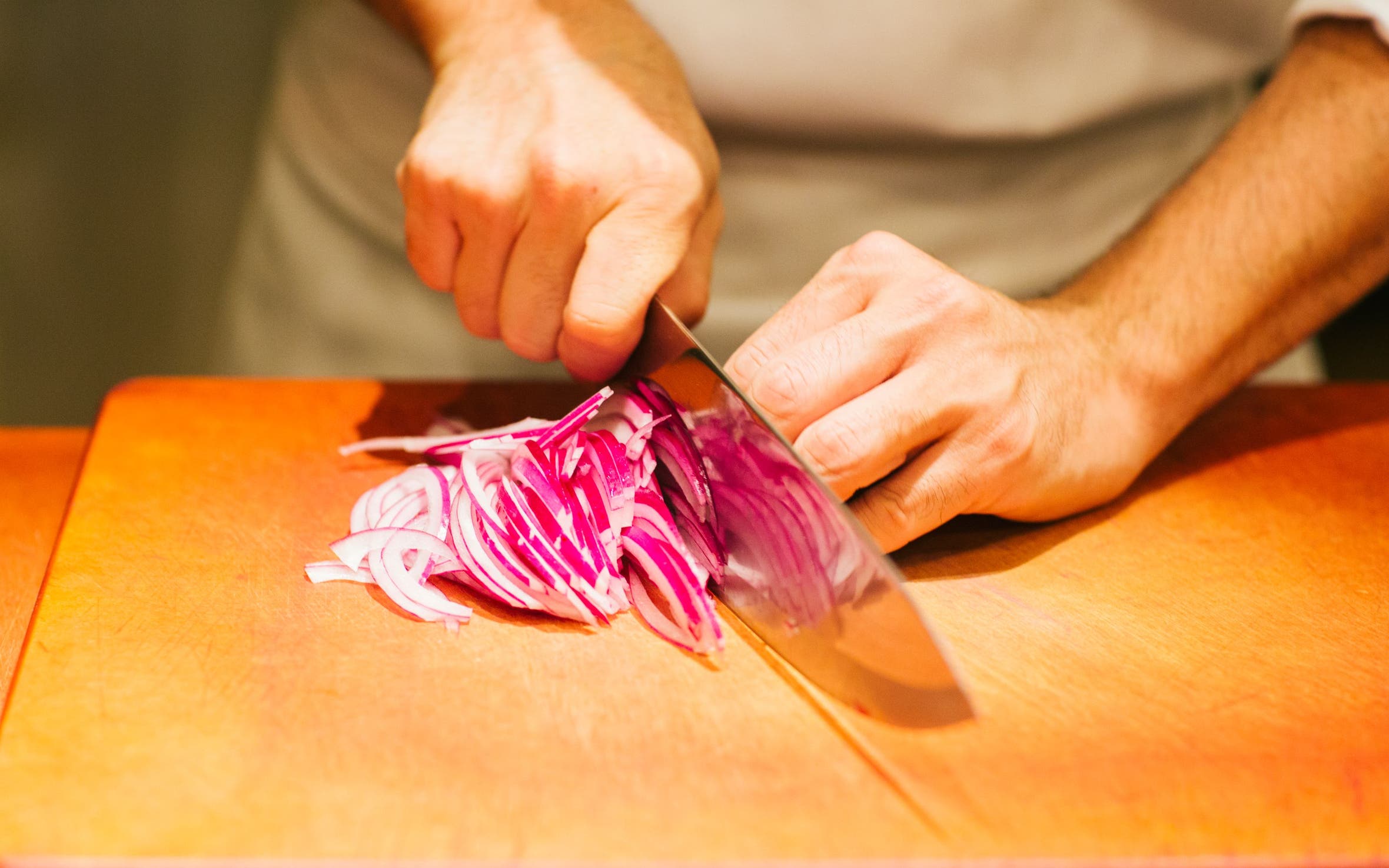 Bazille chef cutting onions.