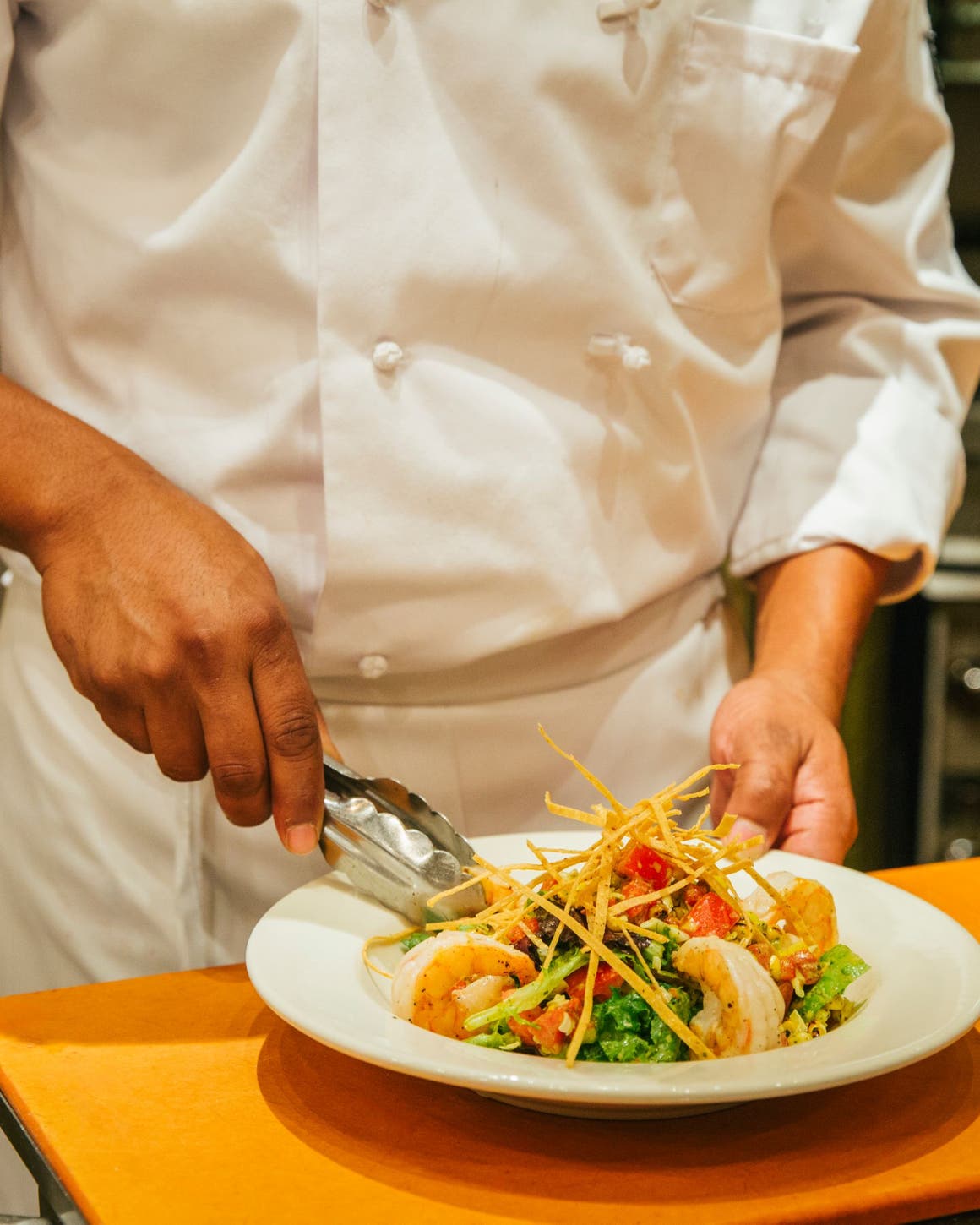 A Nordstrom chef preparing a salad.