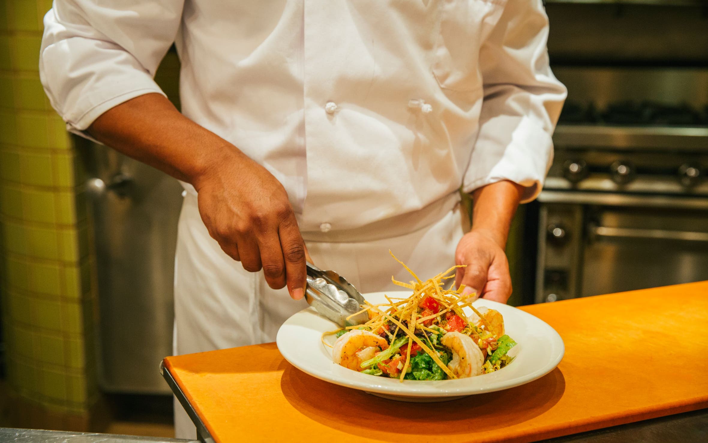 A Nordstrom chef preparing a salad.