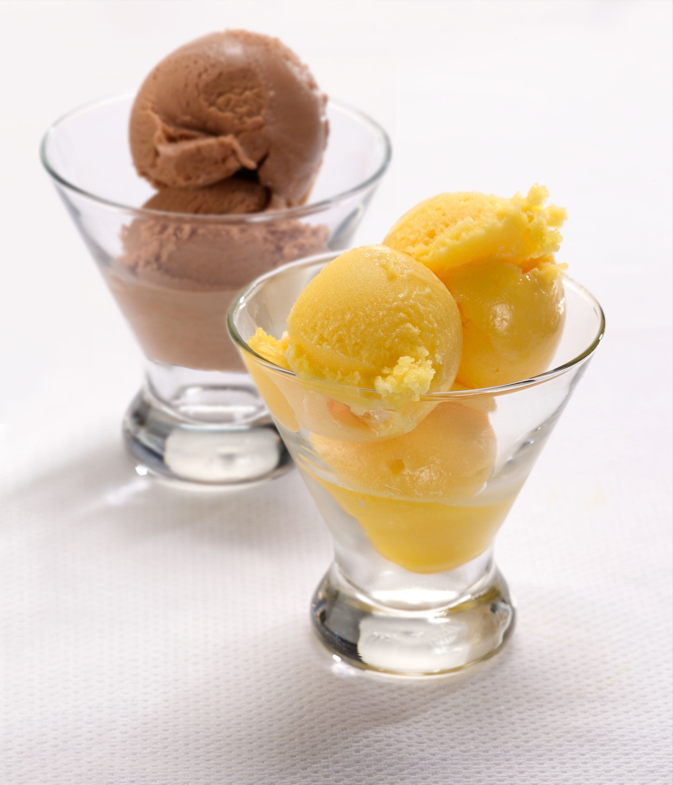 Two coupe glasses filled with gelato. 