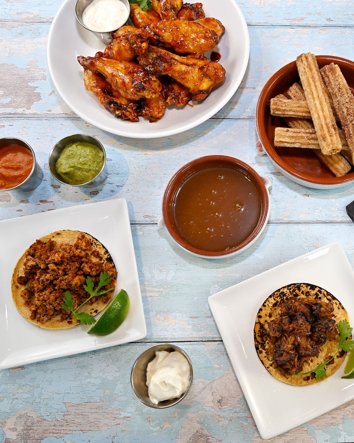 Picnic on 57th: a casual spread of picnic foods and tableware on a rustic blue picnic bench.