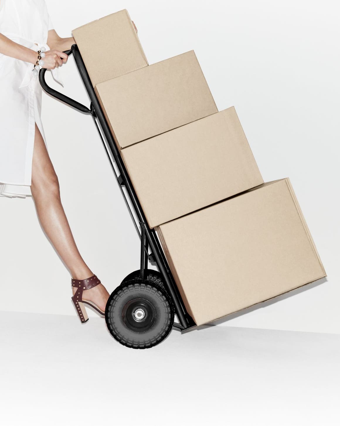 Woman pushing a trolley with boxes.
