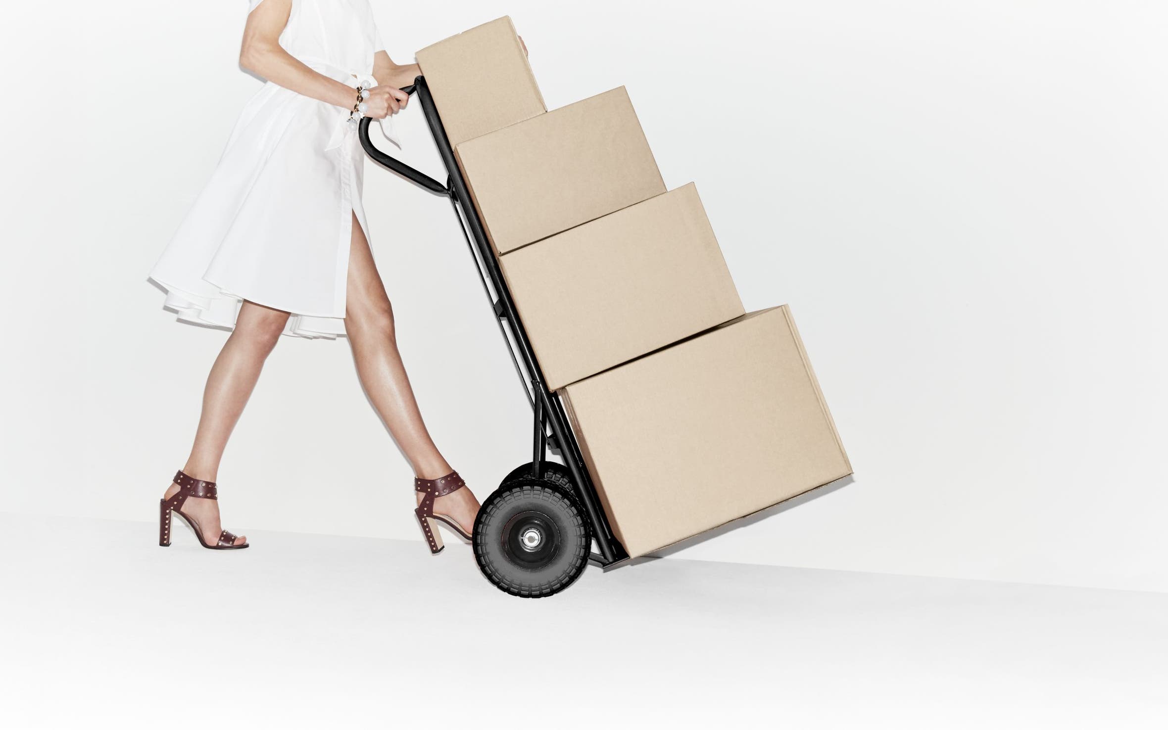 Woman pushing a trolley with boxes.