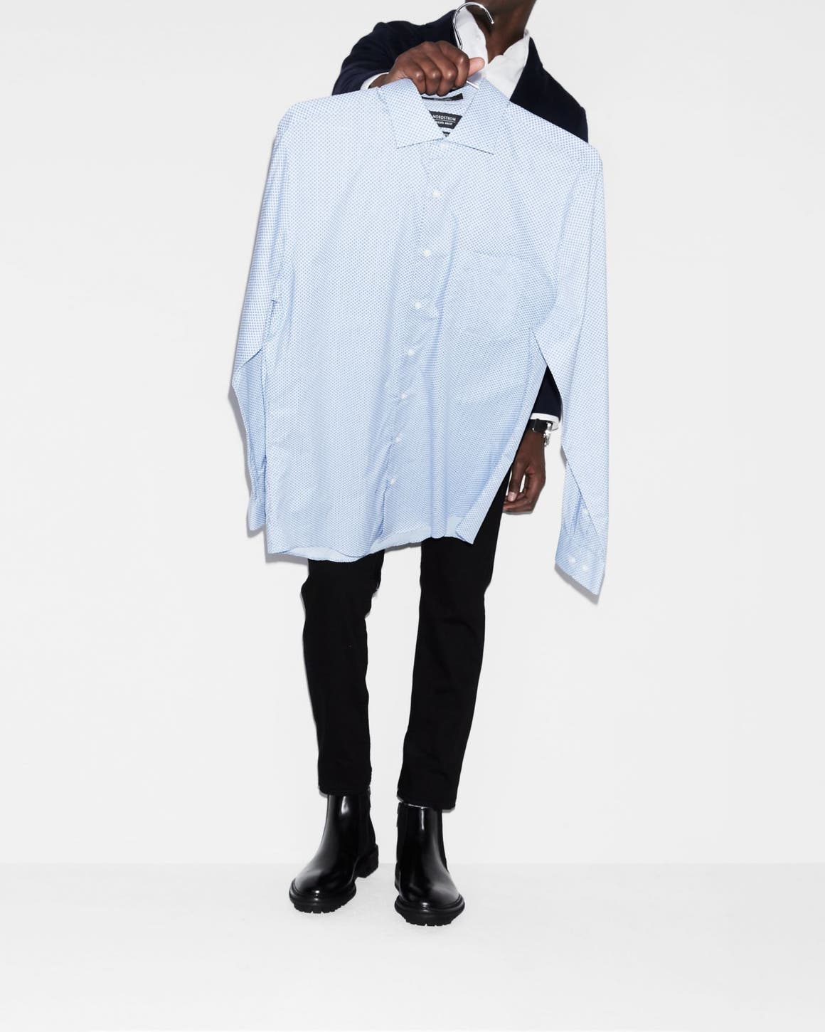 Man carrying a dress shirt. 