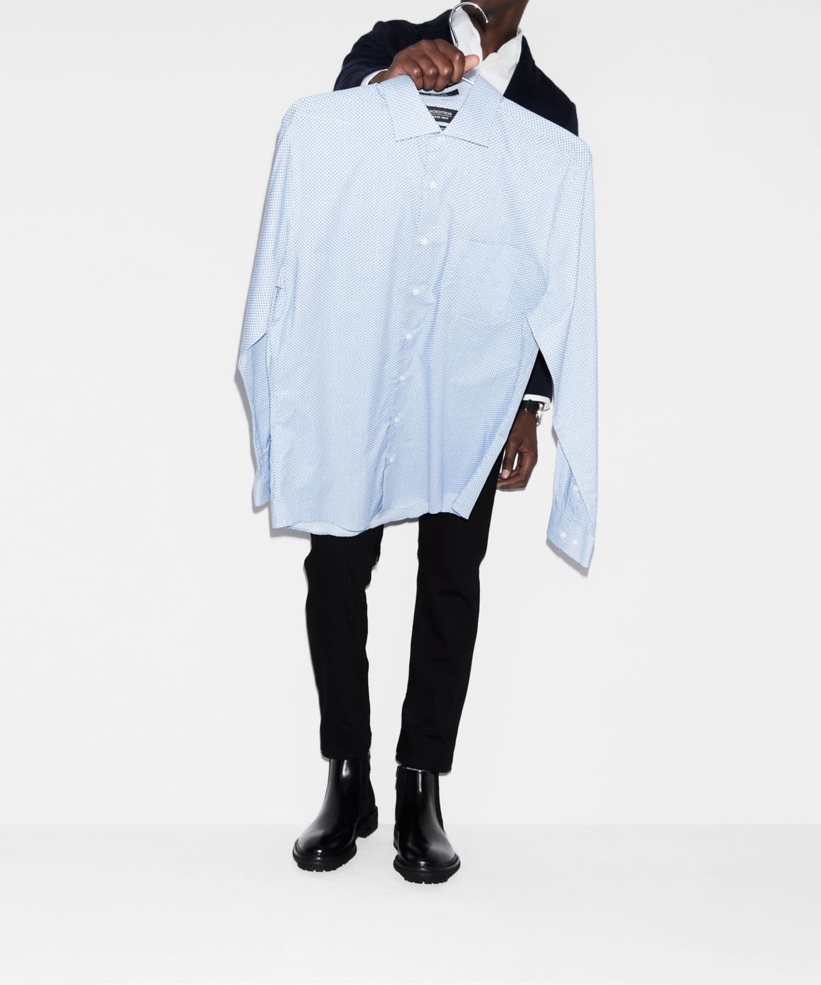 Man carrying a dress shirt. 