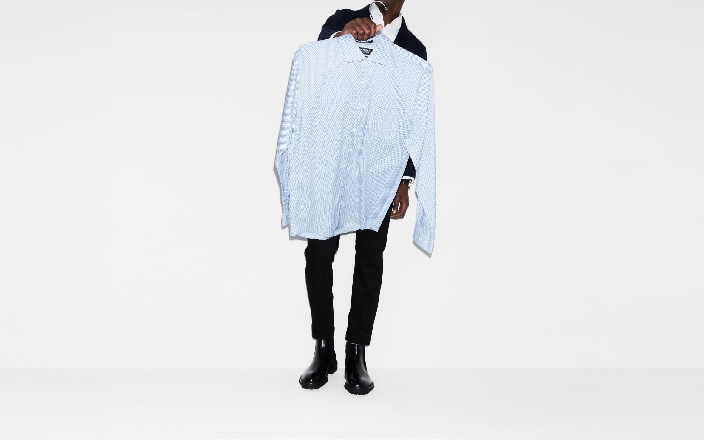 Man carrying a dress shirt. 