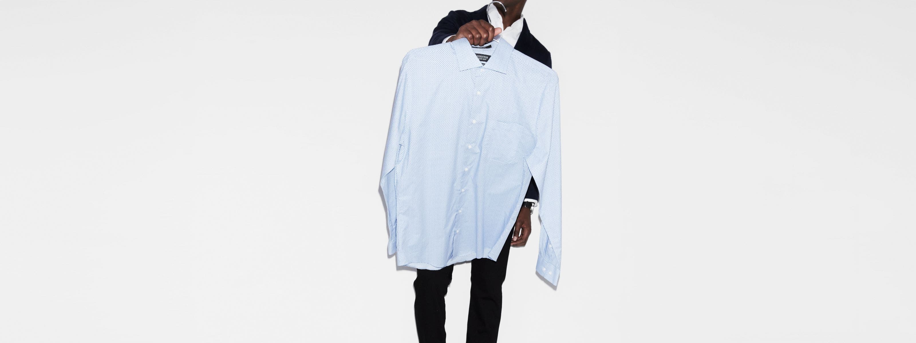 Man carrying a dress shirt. 