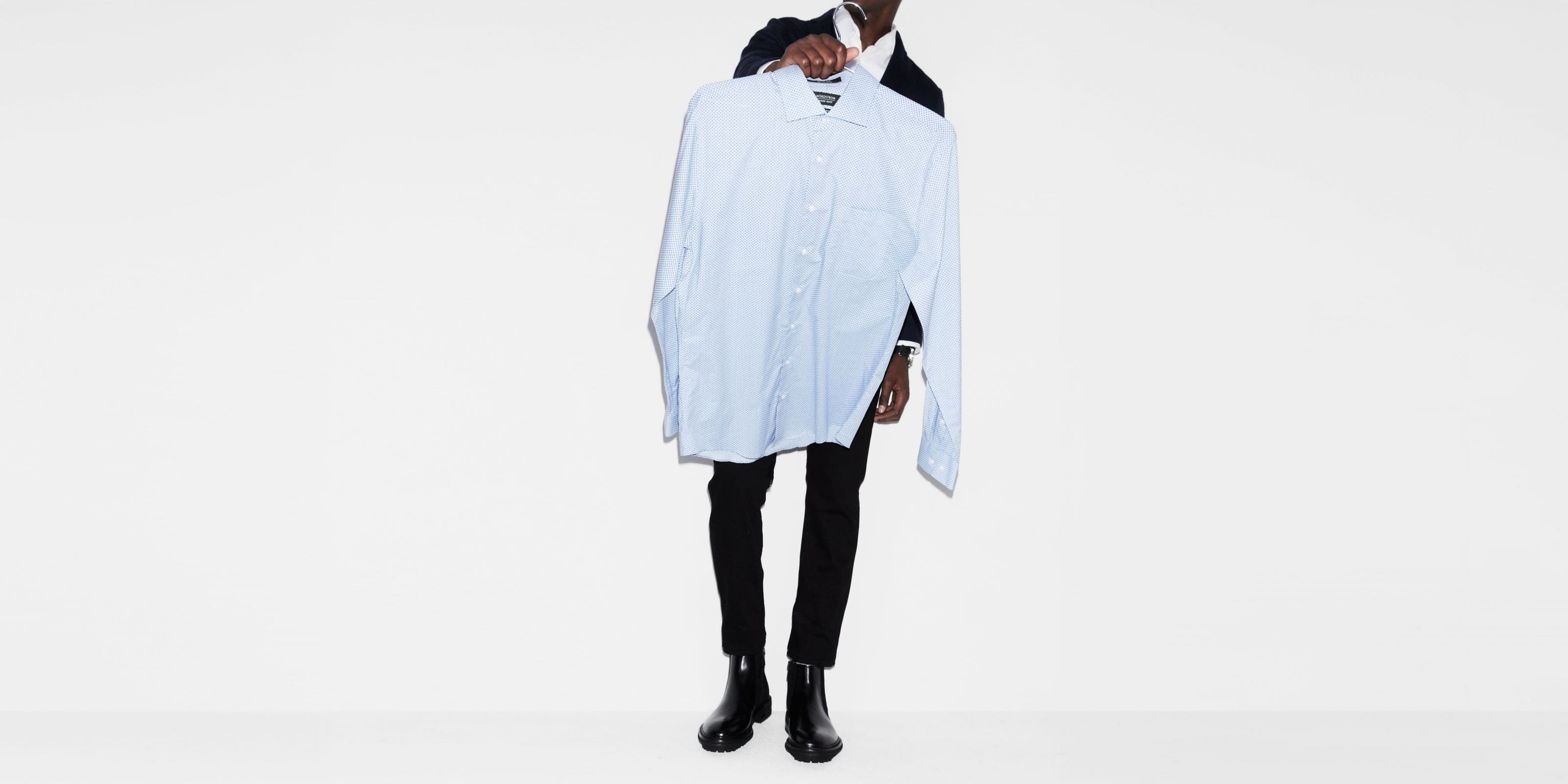 Man carrying a dress shirt. 