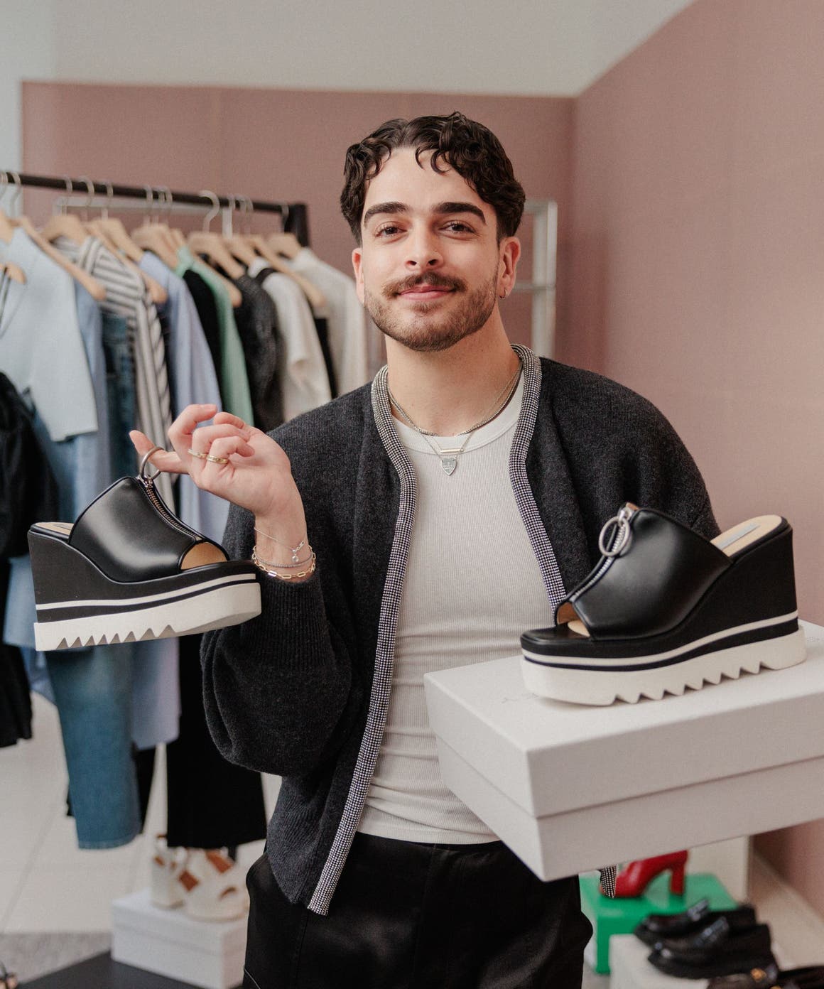Nordstrom salesperson with a pair of shoes in two different sizes.
