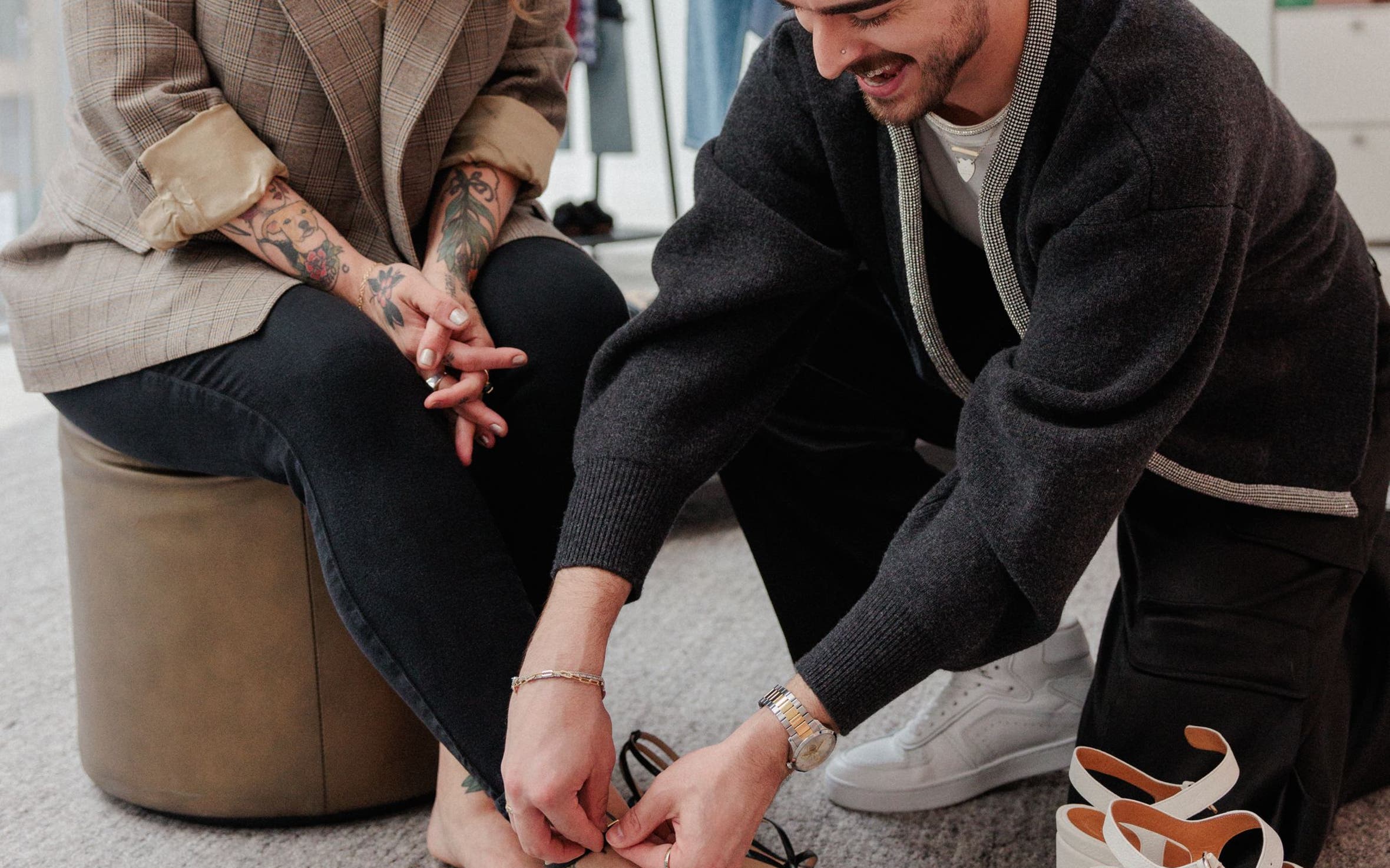 Stylist helping a woman with a heel strap.