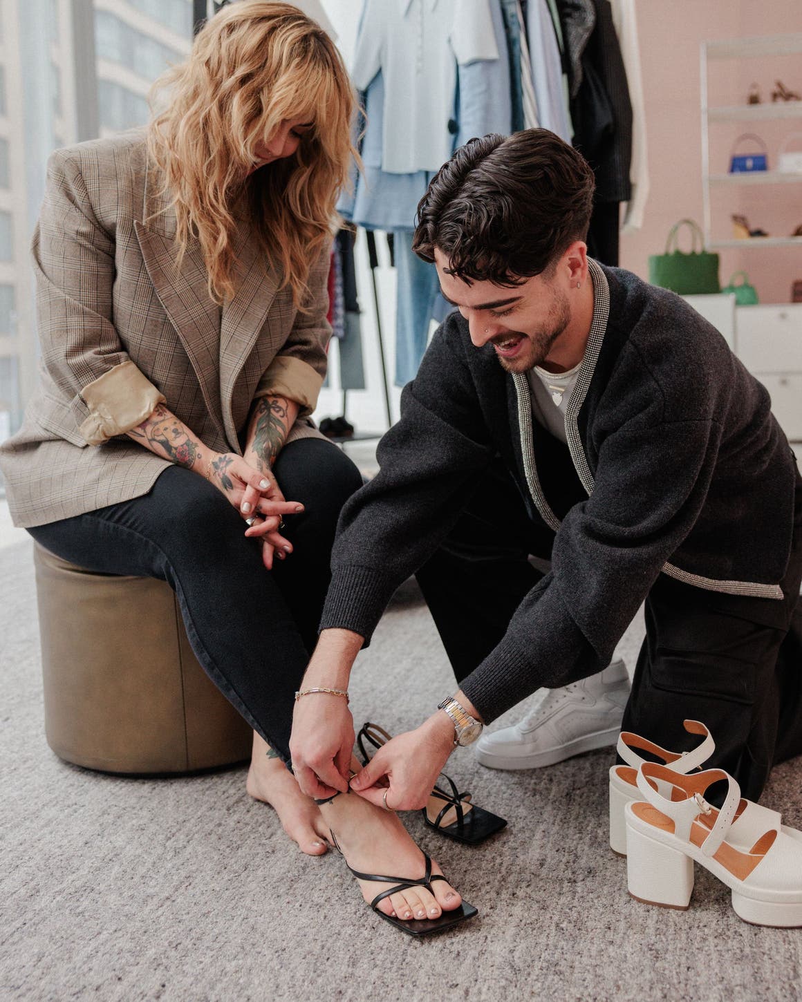 Stylist helping a woman with a heel strap.