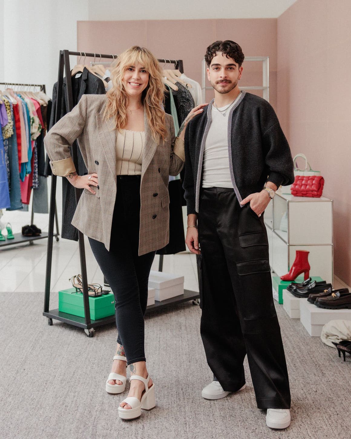 Nordstrom stylists with racks of clothes. 