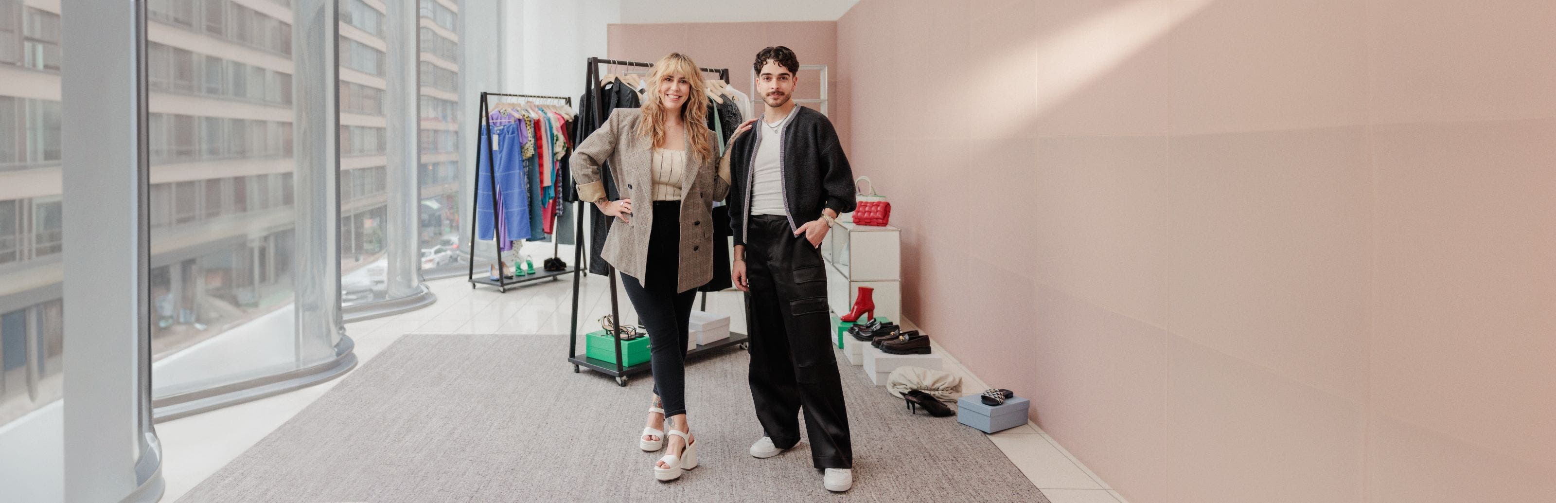 Two Nordstrom stylists in front of racks of clothing, shoes and accessories.