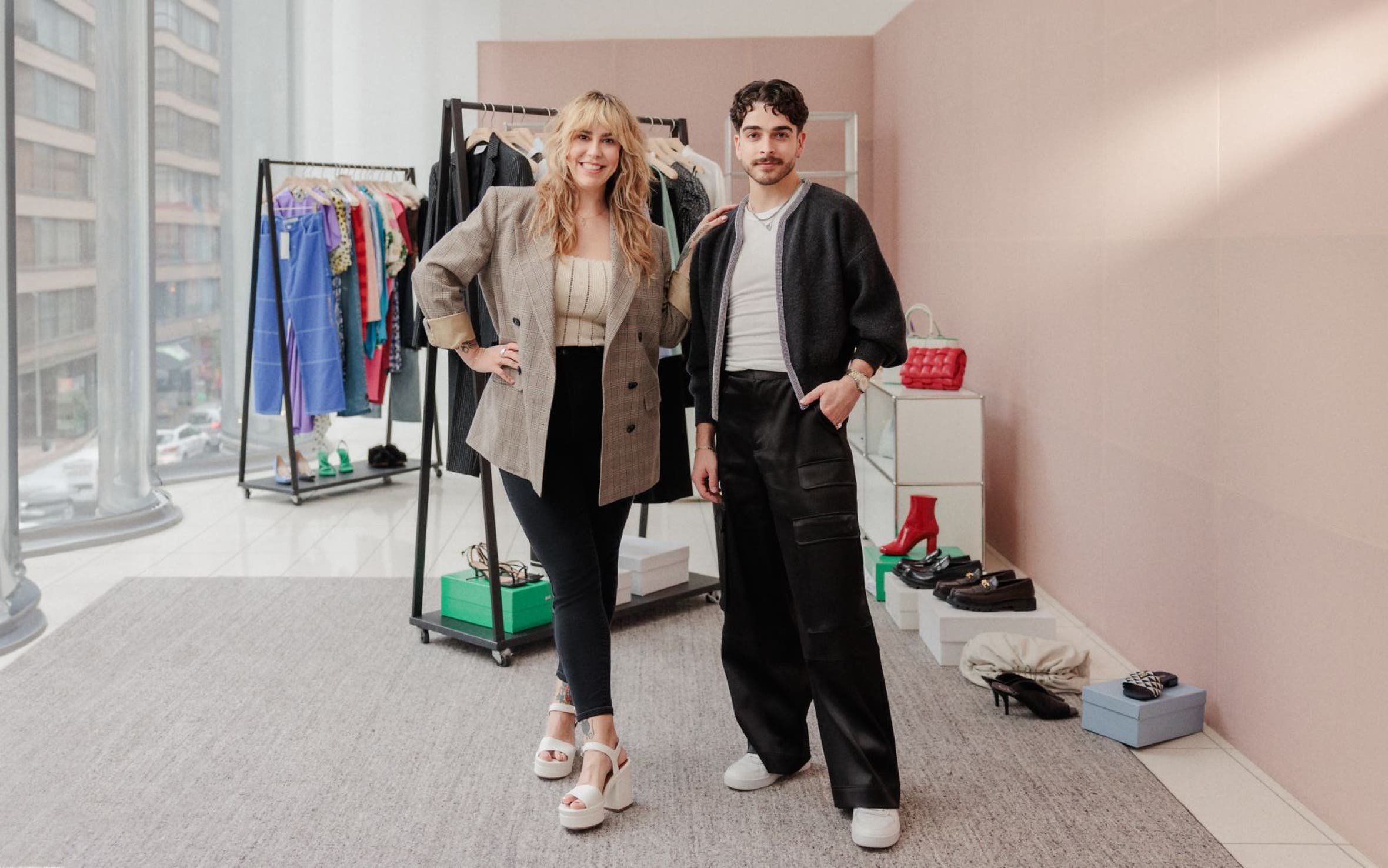 Two Nordstrom stylists in front of racks of clothing, shoes and accessories.