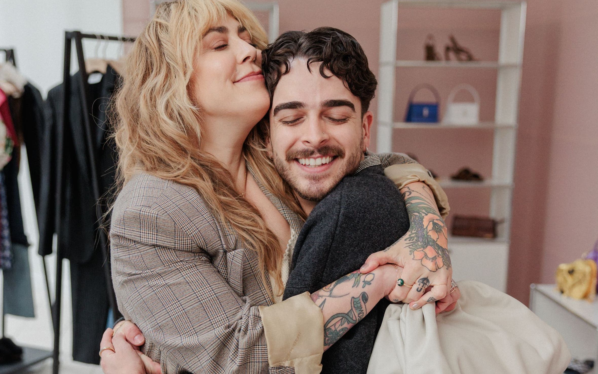 Woman and stylist hugging.