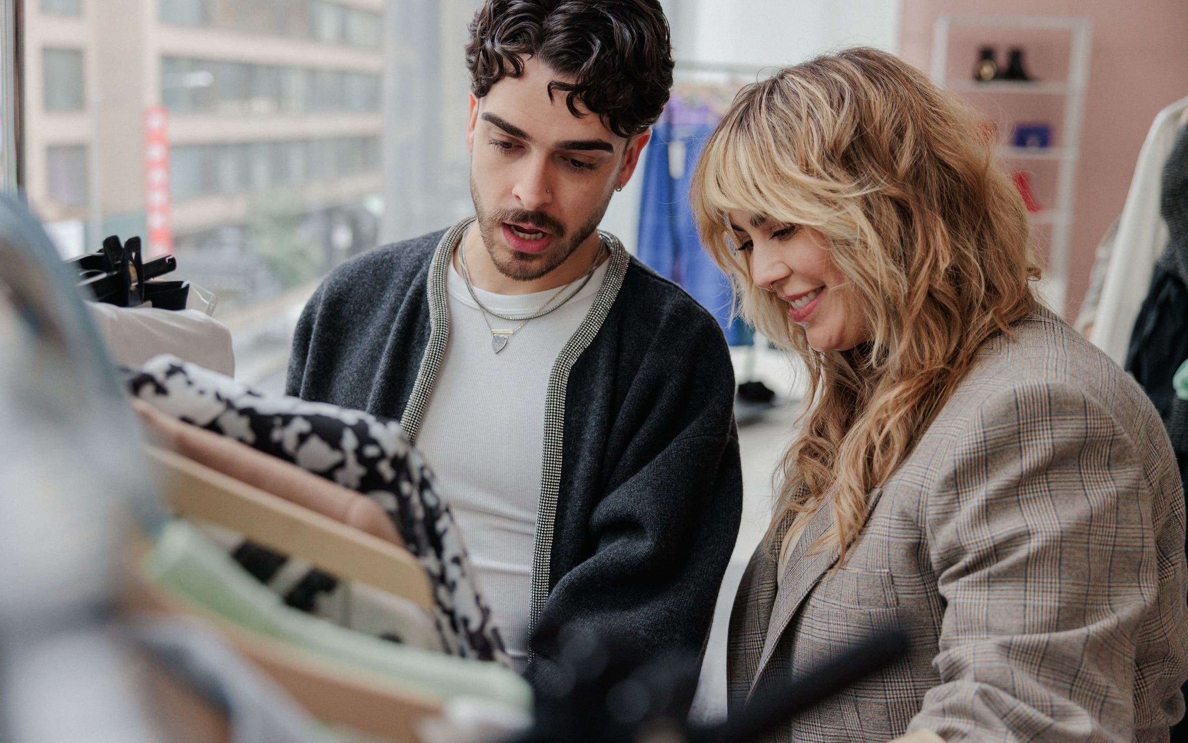 A Nordstrom stylist helping a man shop.