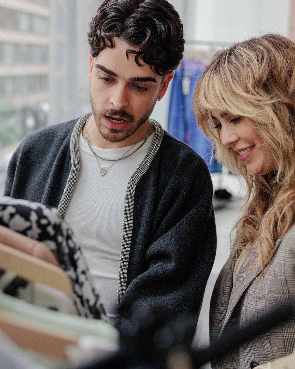 A Nordstrom stylist helping a man shop.