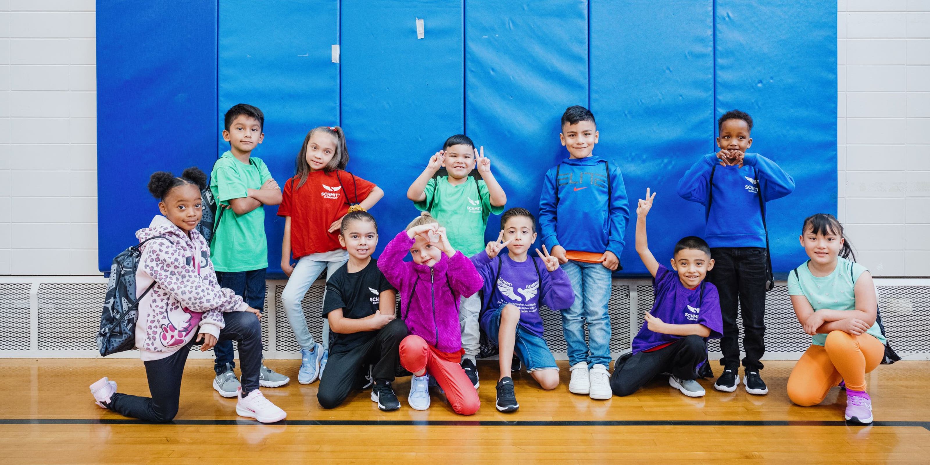 Kids with their new shoes pose for a group photo.
