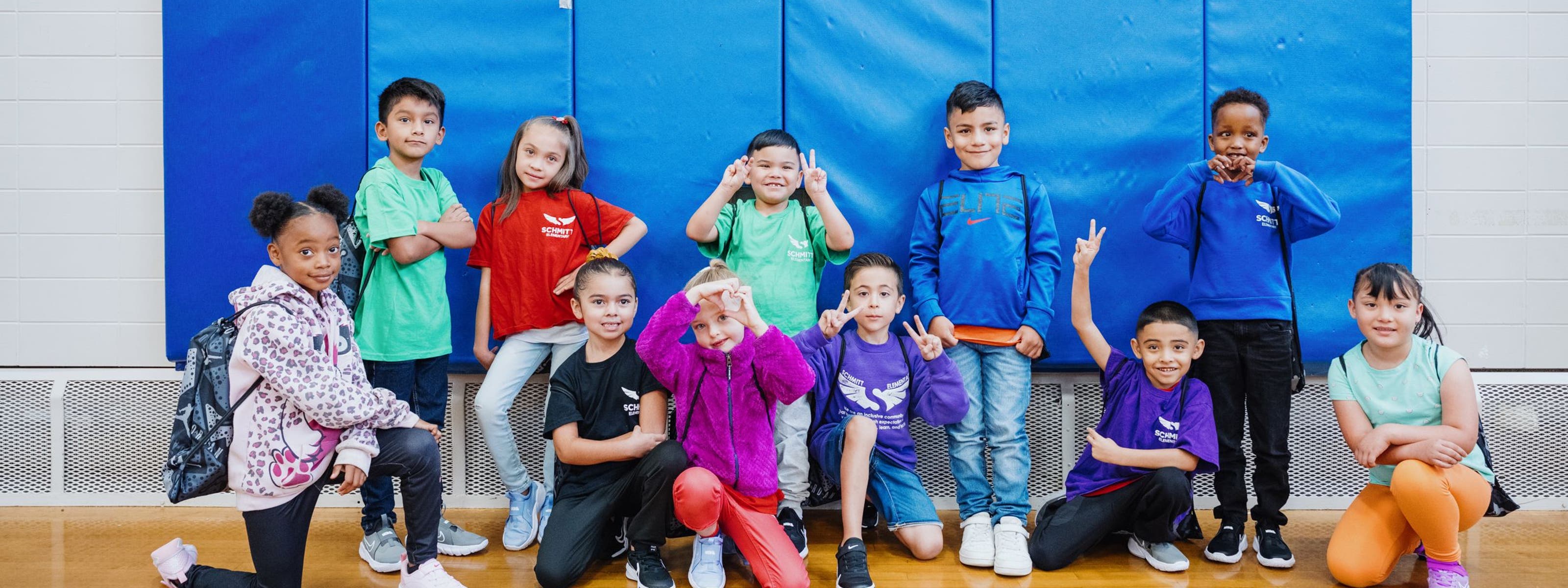 Kids with their new shoes pose for a group photo.
