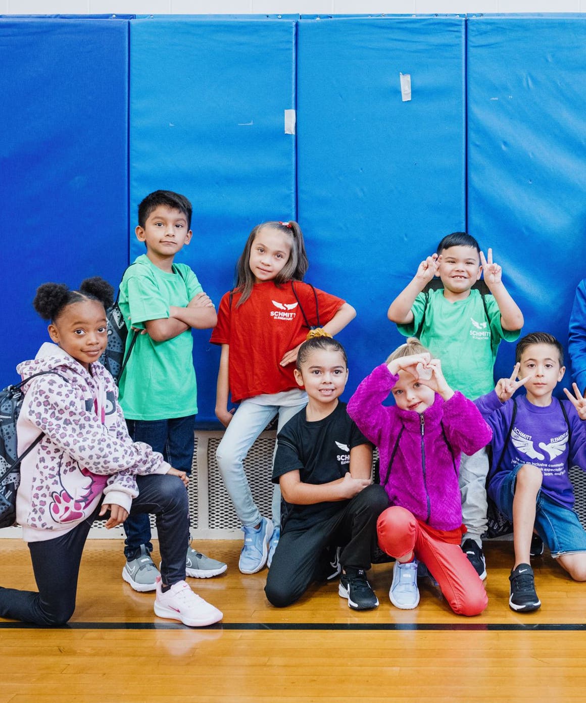 Kids with their new shoes pose for a group photo.