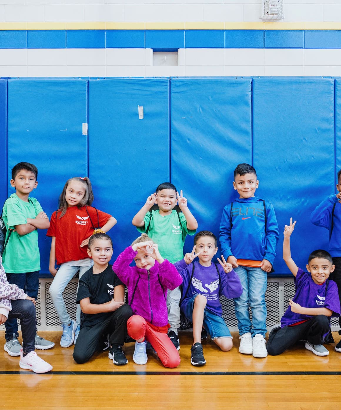 Kids with their new shoes pose for a group photo.