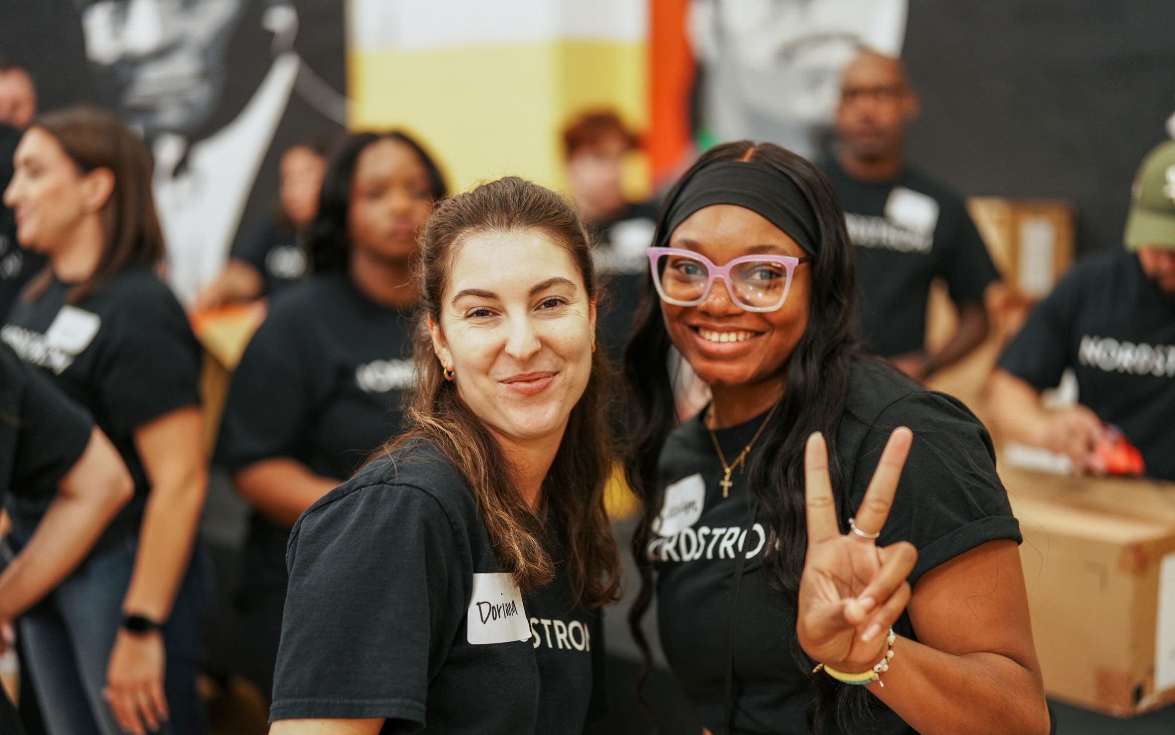Two volunteers at a Shoes That Fit event.