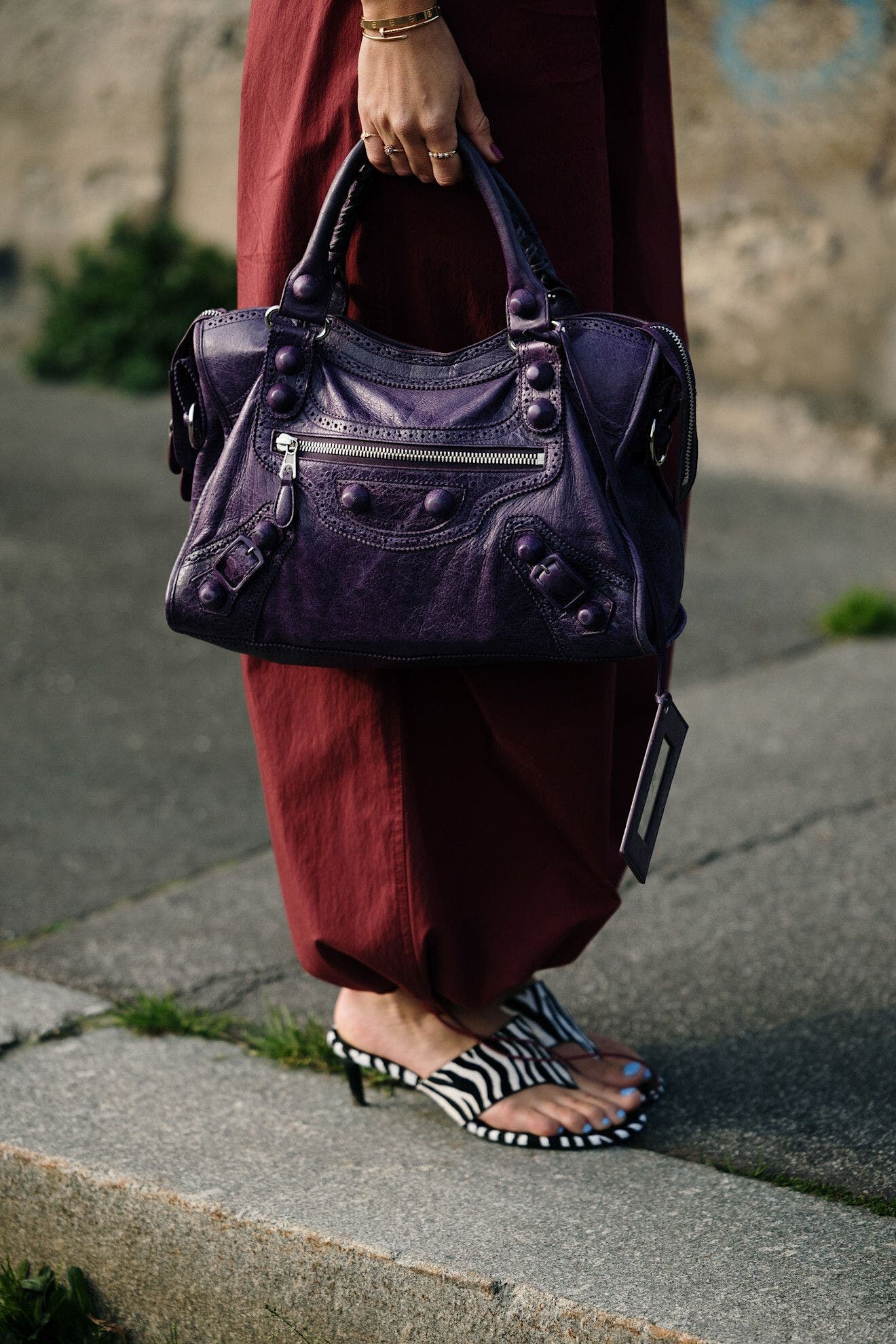 Woman carrying a Balenciaga bag at Milan Fashion Week.