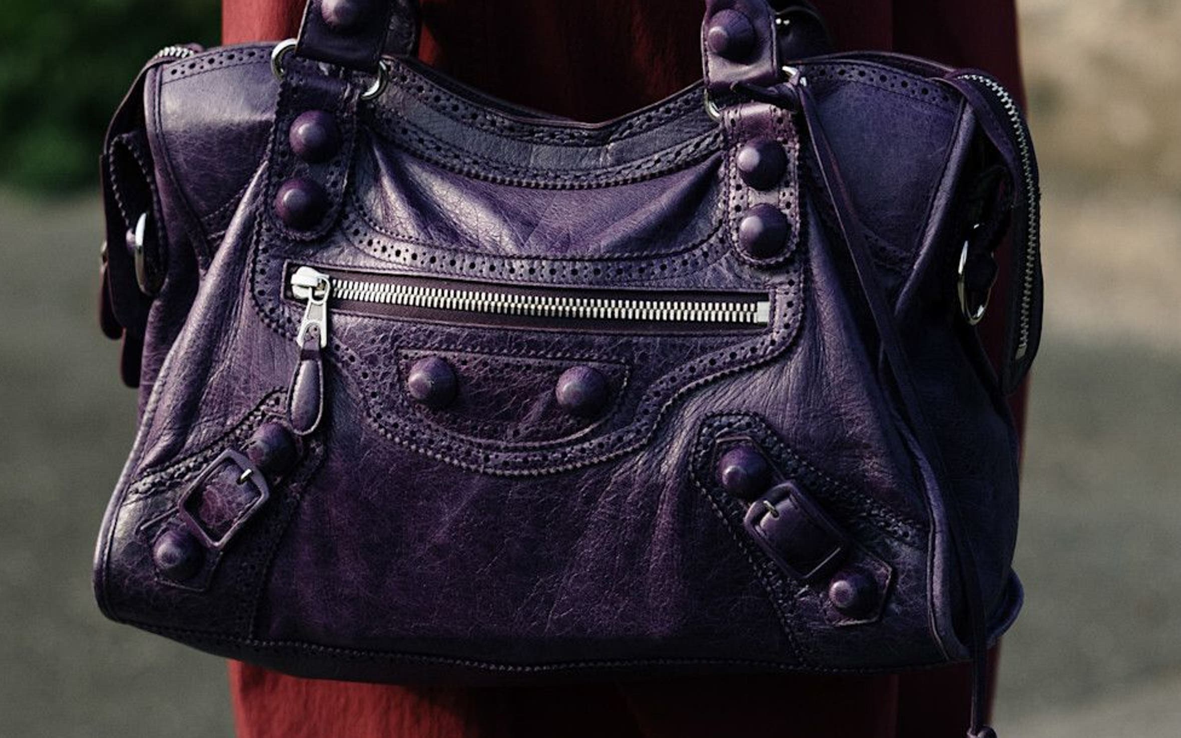 Woman carrying a Balenciaga bag at Milan Fashion Week.