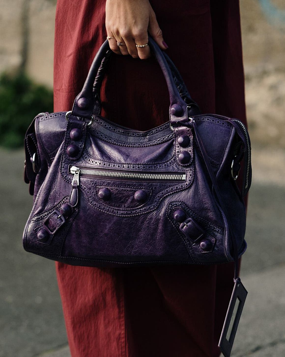 Woman carrying a Balenciaga bag at Milan Fashion Week.