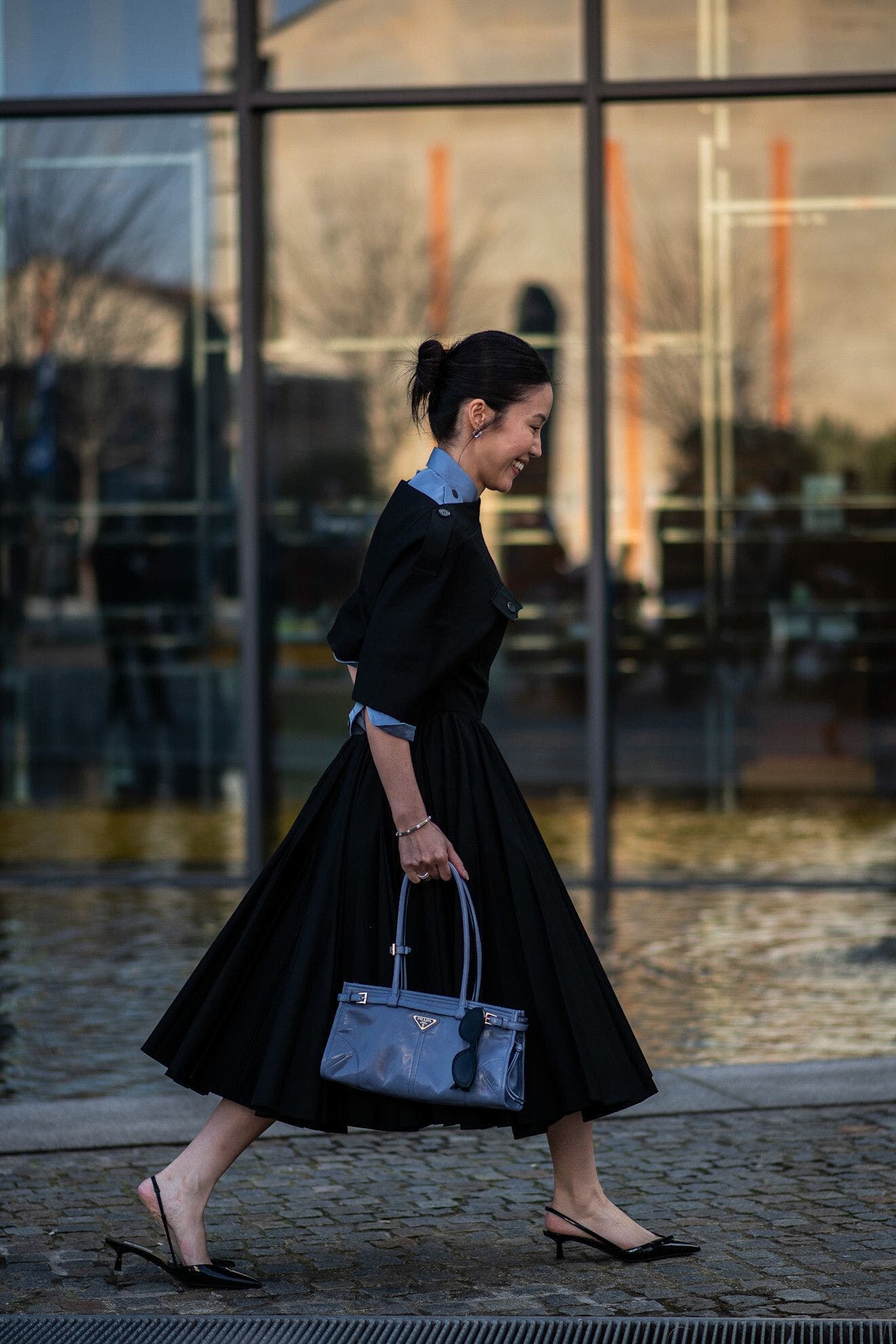 Woman wearing a fit-and-flare dress at Milan Fashion Week.