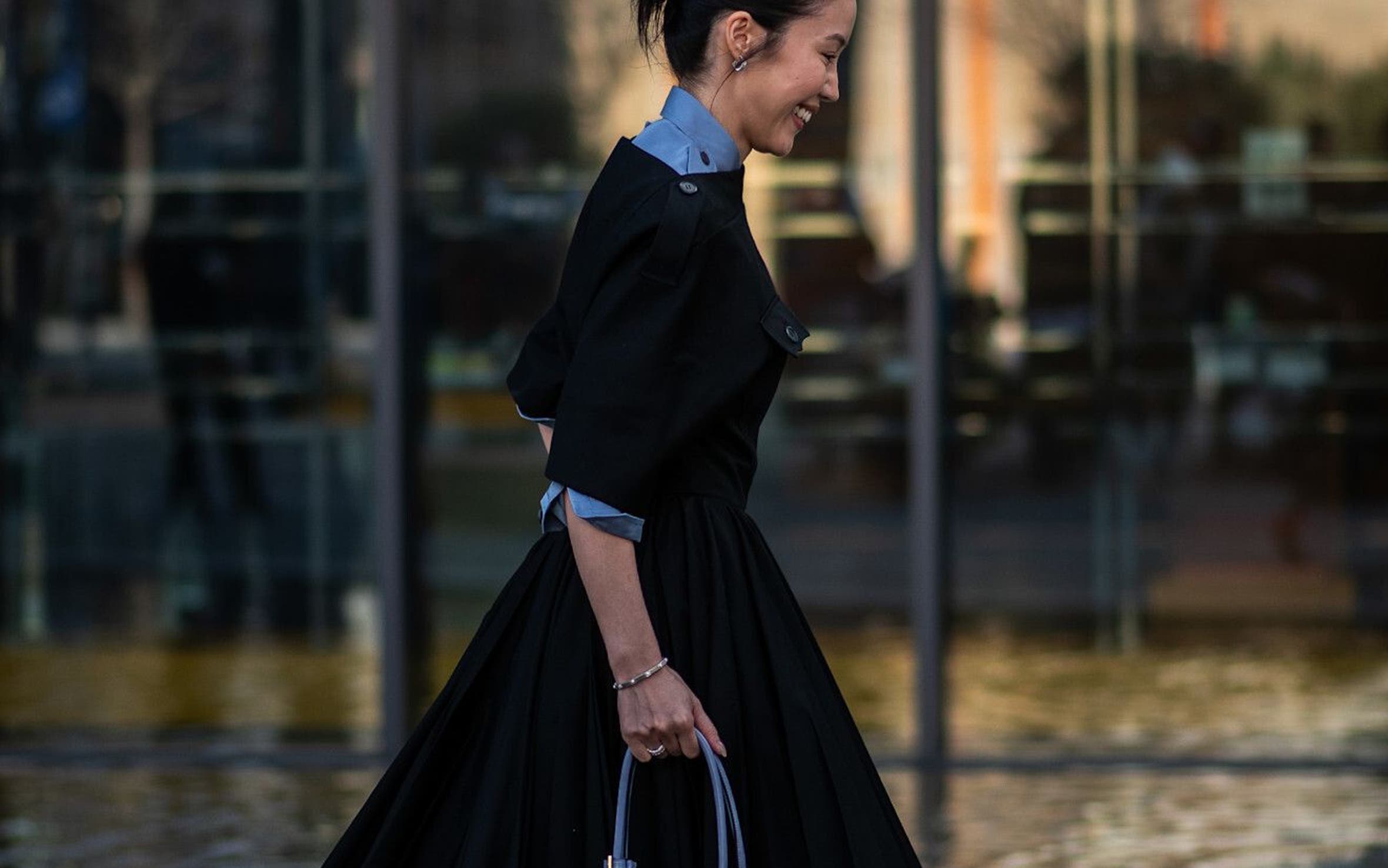 Woman wearing a fit-and-flare dress at Milan Fashion Week.