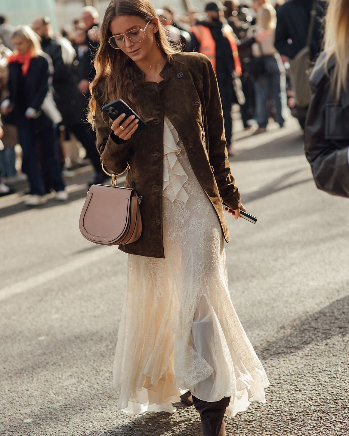 Woman wearing a lace dress at Paris Fashion Week.
