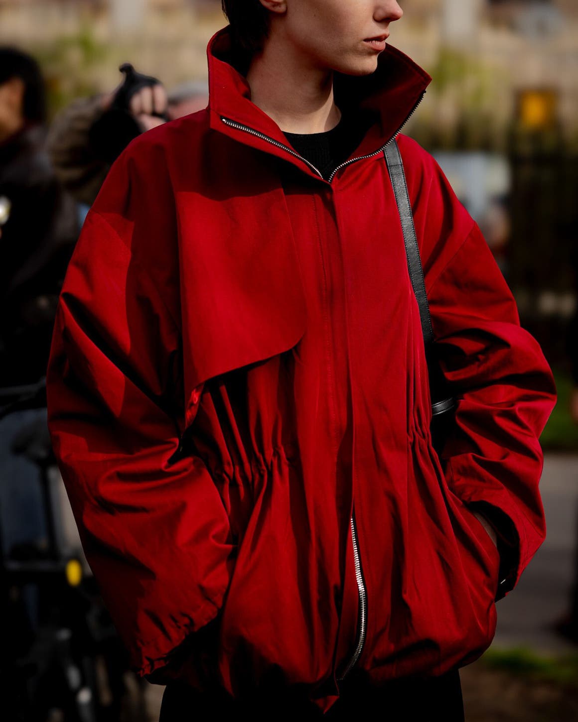 Woman wearing a red jacket at Paris Fashion Week.