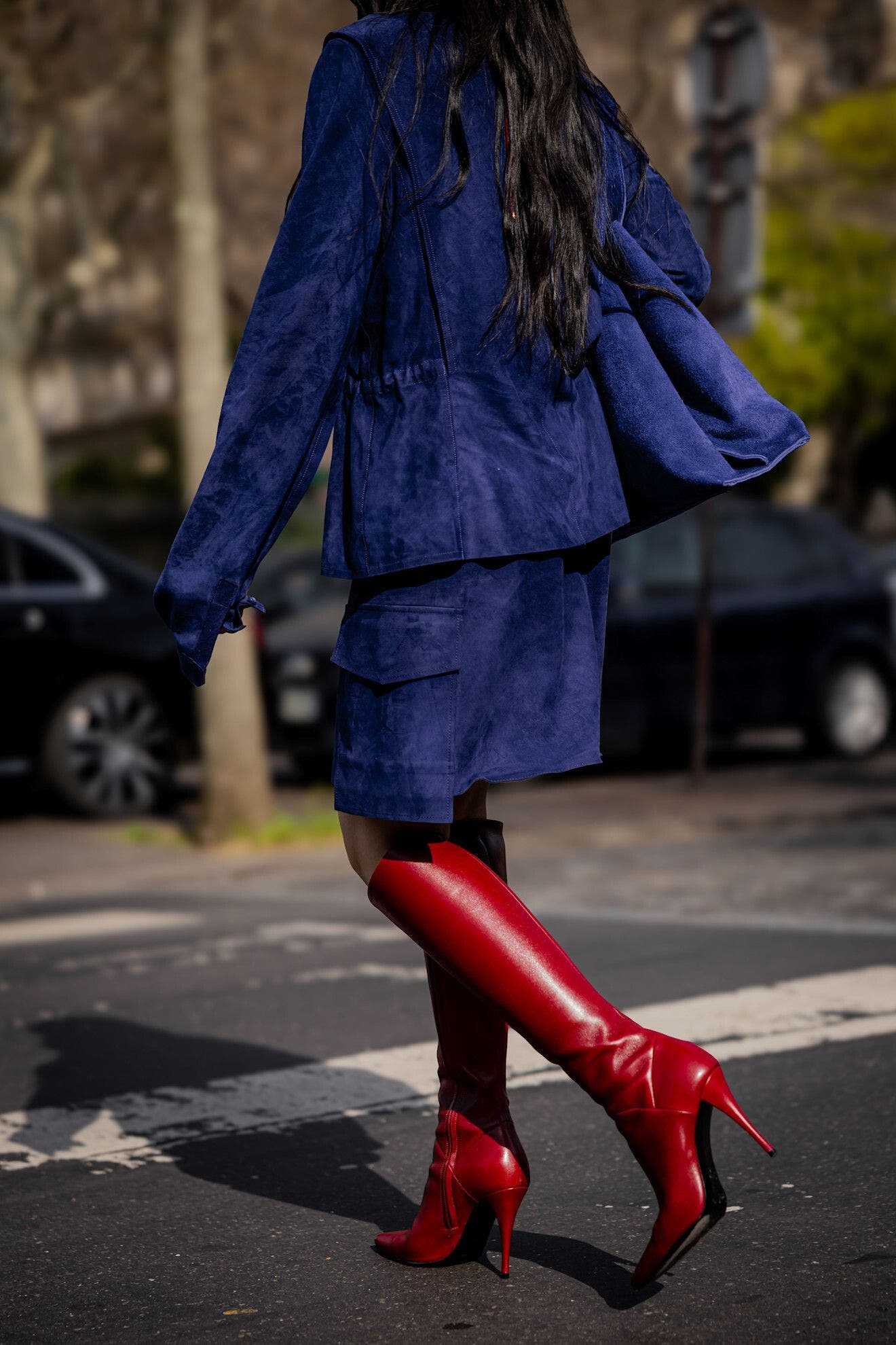 Woman wearing red boots at Paris Fashion Week.