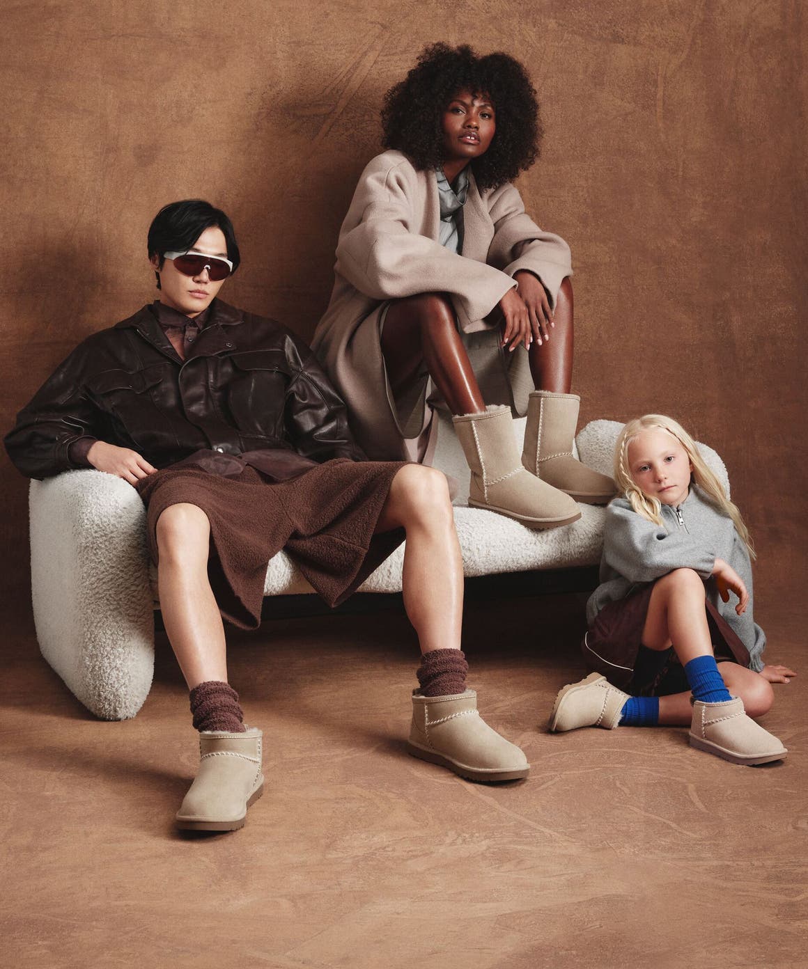 Two adults and a child wearing Nordstrom-exclusive UGG boots. 