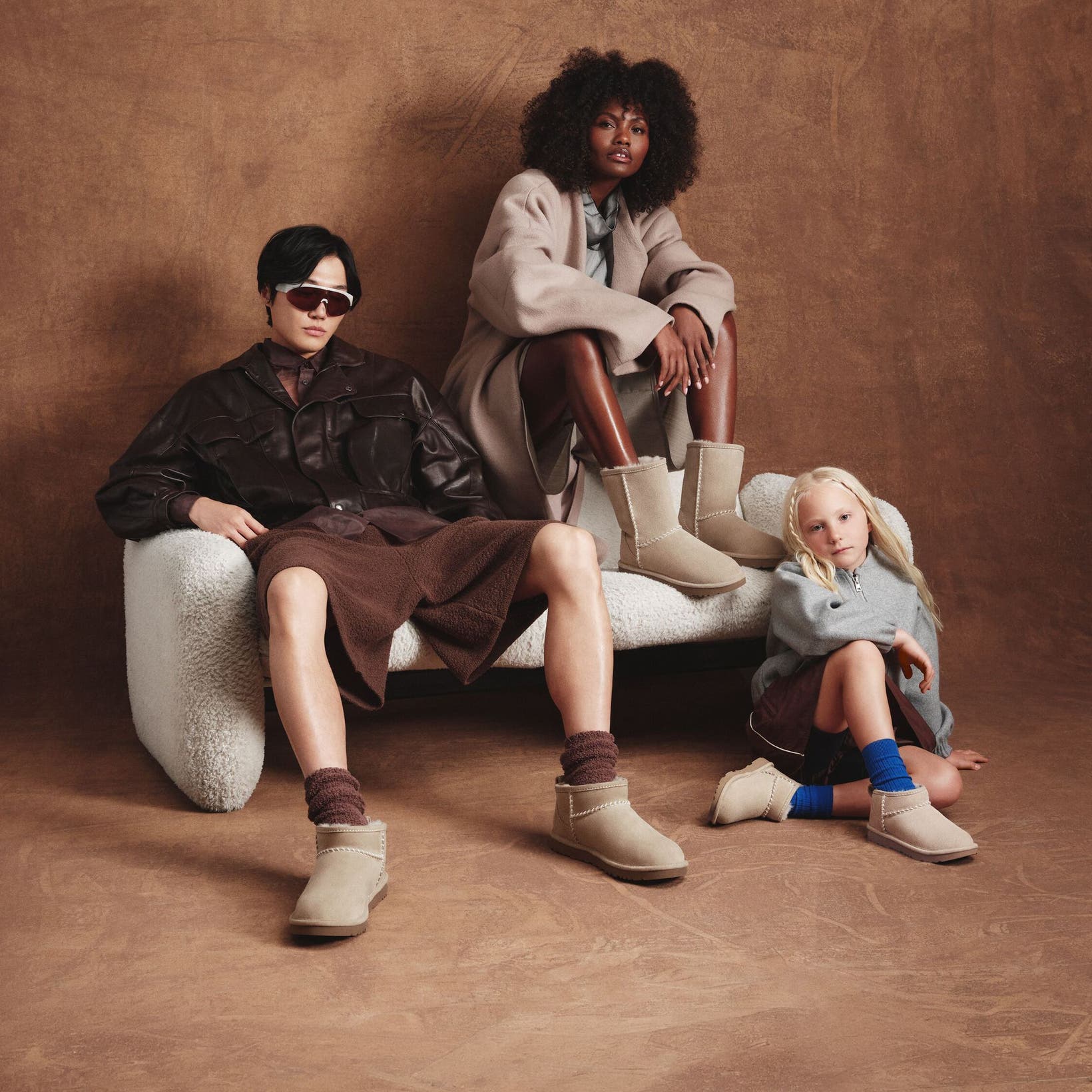 Two adults and a child wearing Nordstrom-exclusive UGG boots. 