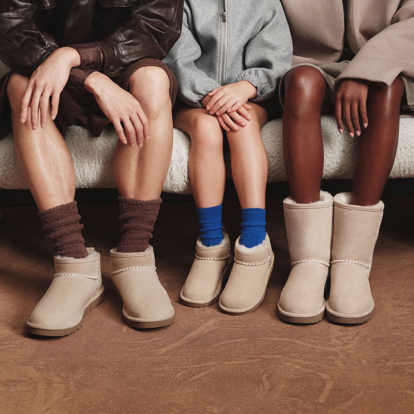 Two adults and a child wearing Nordstrom-exclusive UGG boots. 
