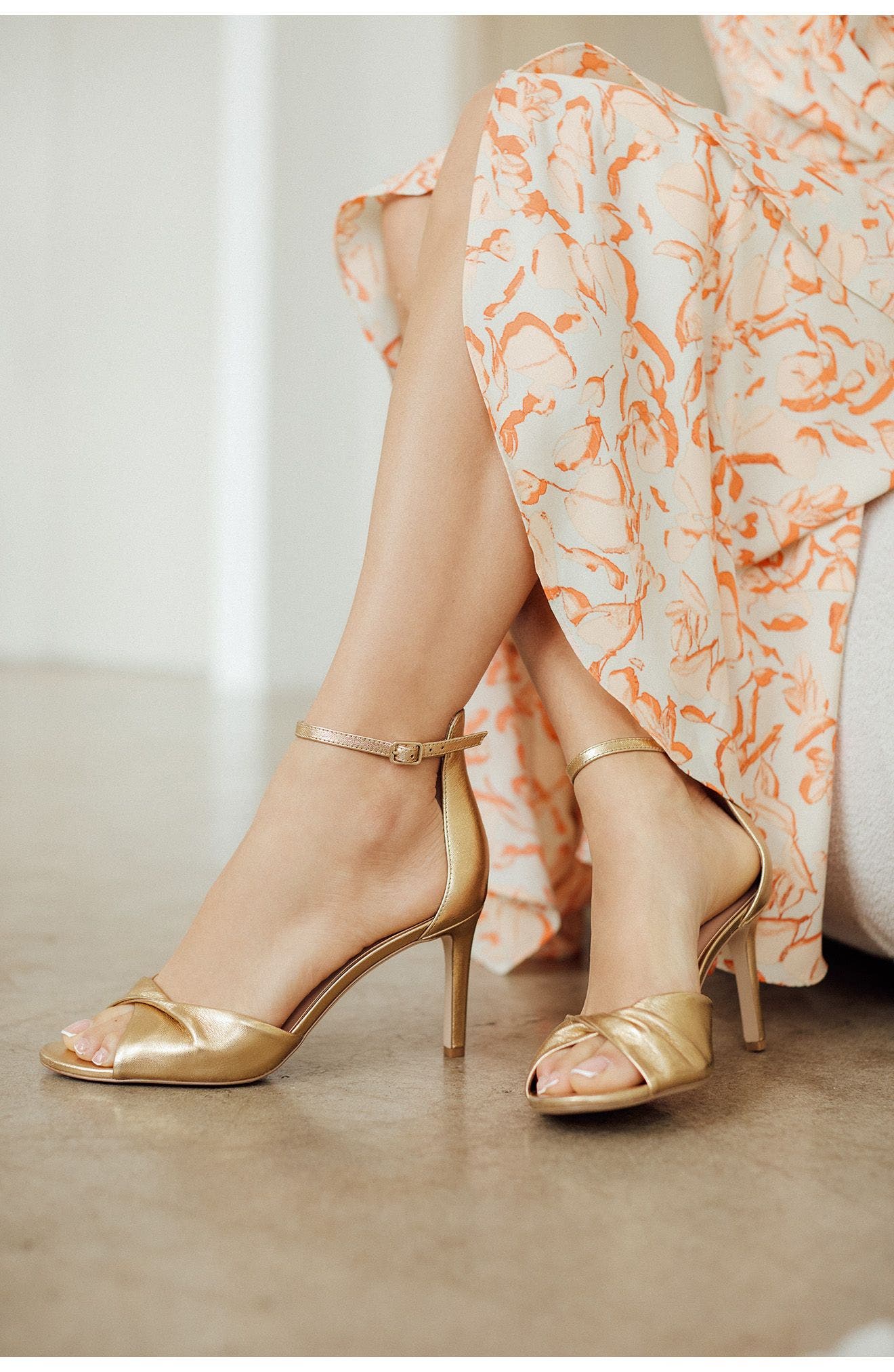 Gold satin shoes and a printed dress.