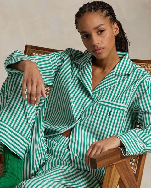 A woman wearing green striped pajamas. 