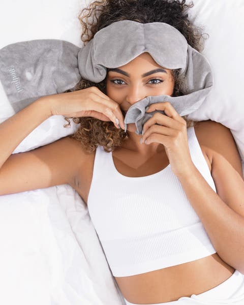 A woman wearing an eye mask. 