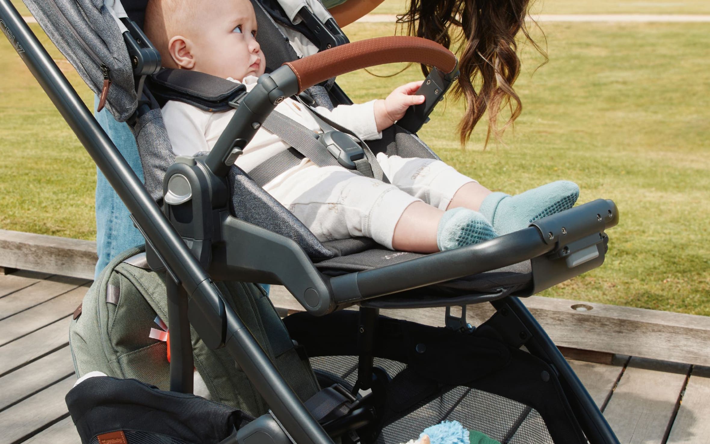 A woman with her baby in a stroller from Uppababy.