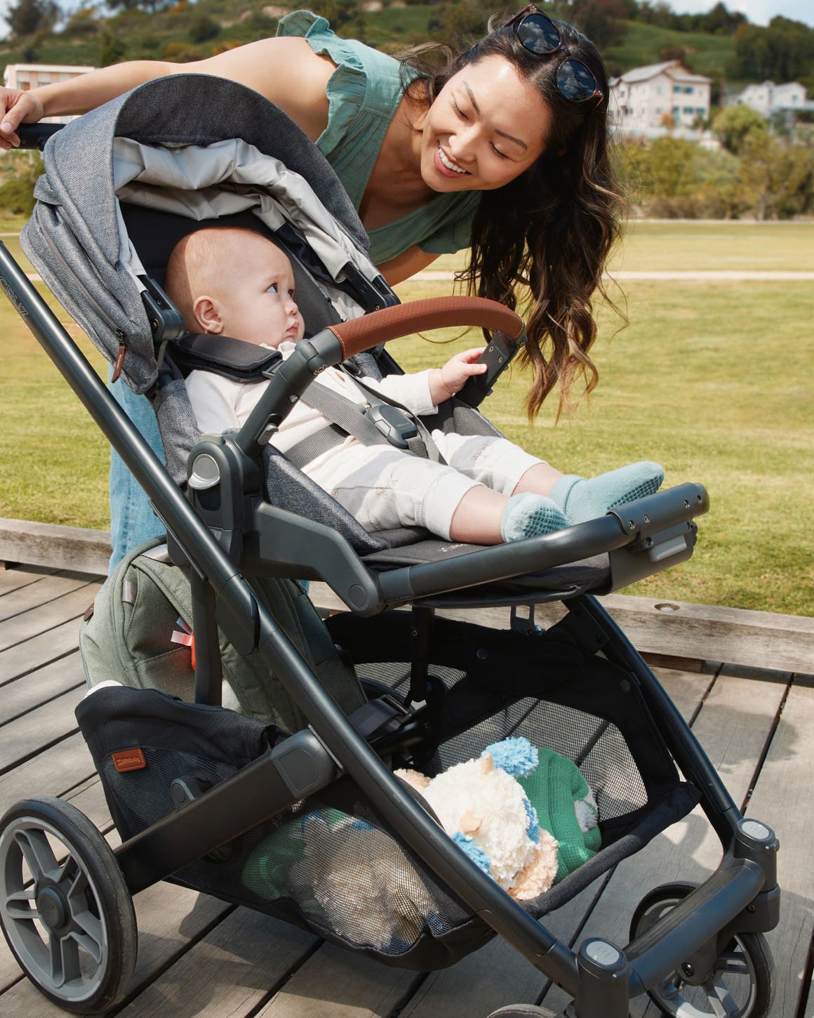 A woman with her baby in a stroller from Uppababy.