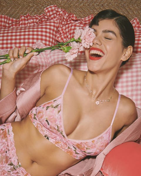 A woman wearing a matching floral-print lace bralette and panties.