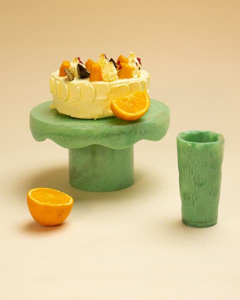 A cake stand with an orange and matching cup.