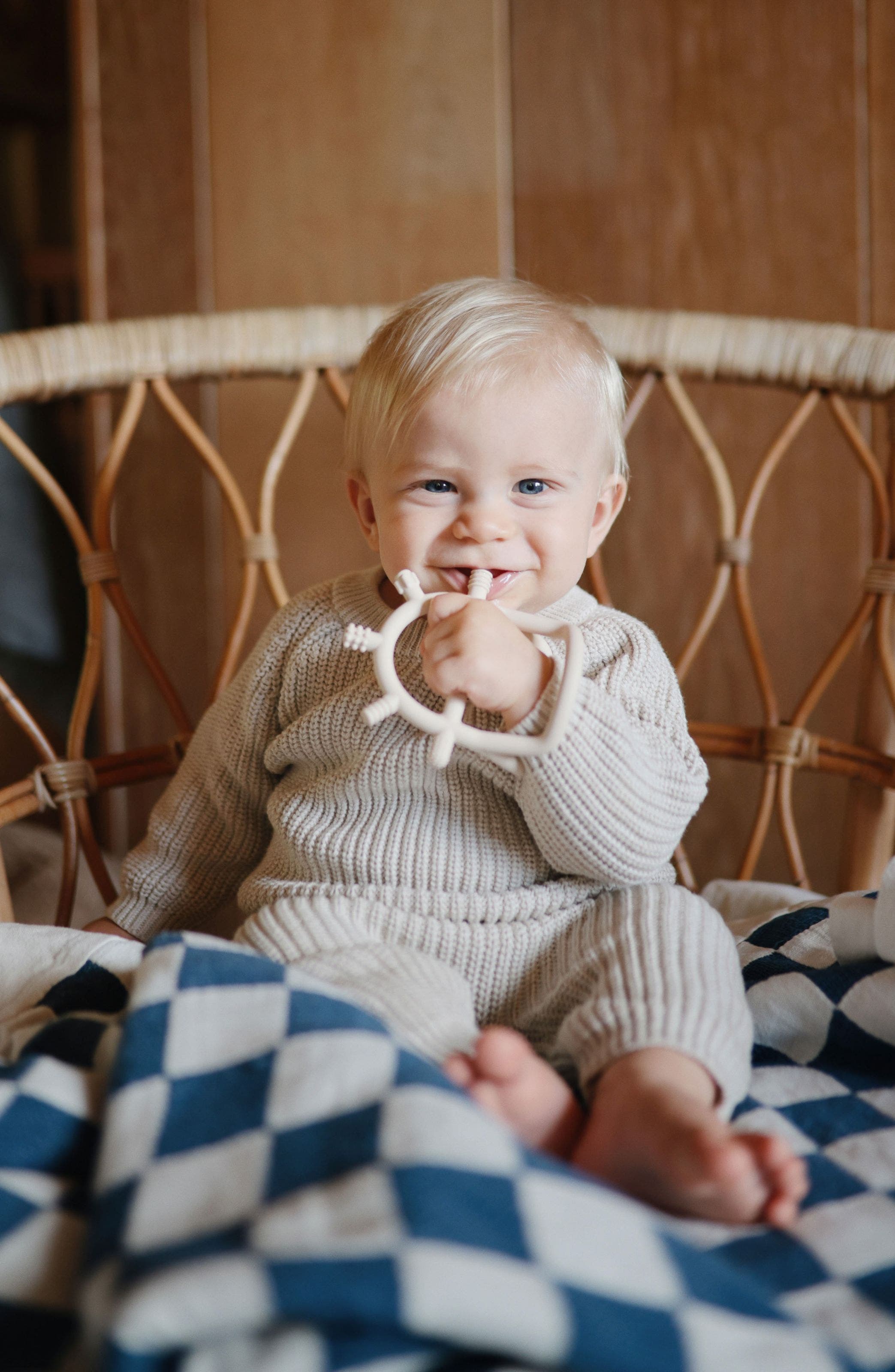 A baby holding a teething toy. 