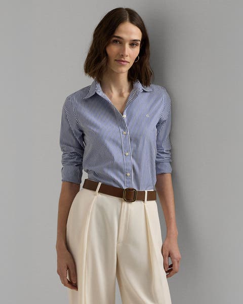 A woman wearing a striped button-up shirt with trousers.