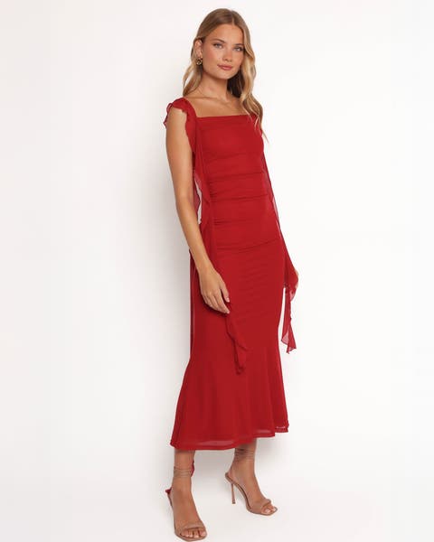 A woman wearing a red midi dress.
