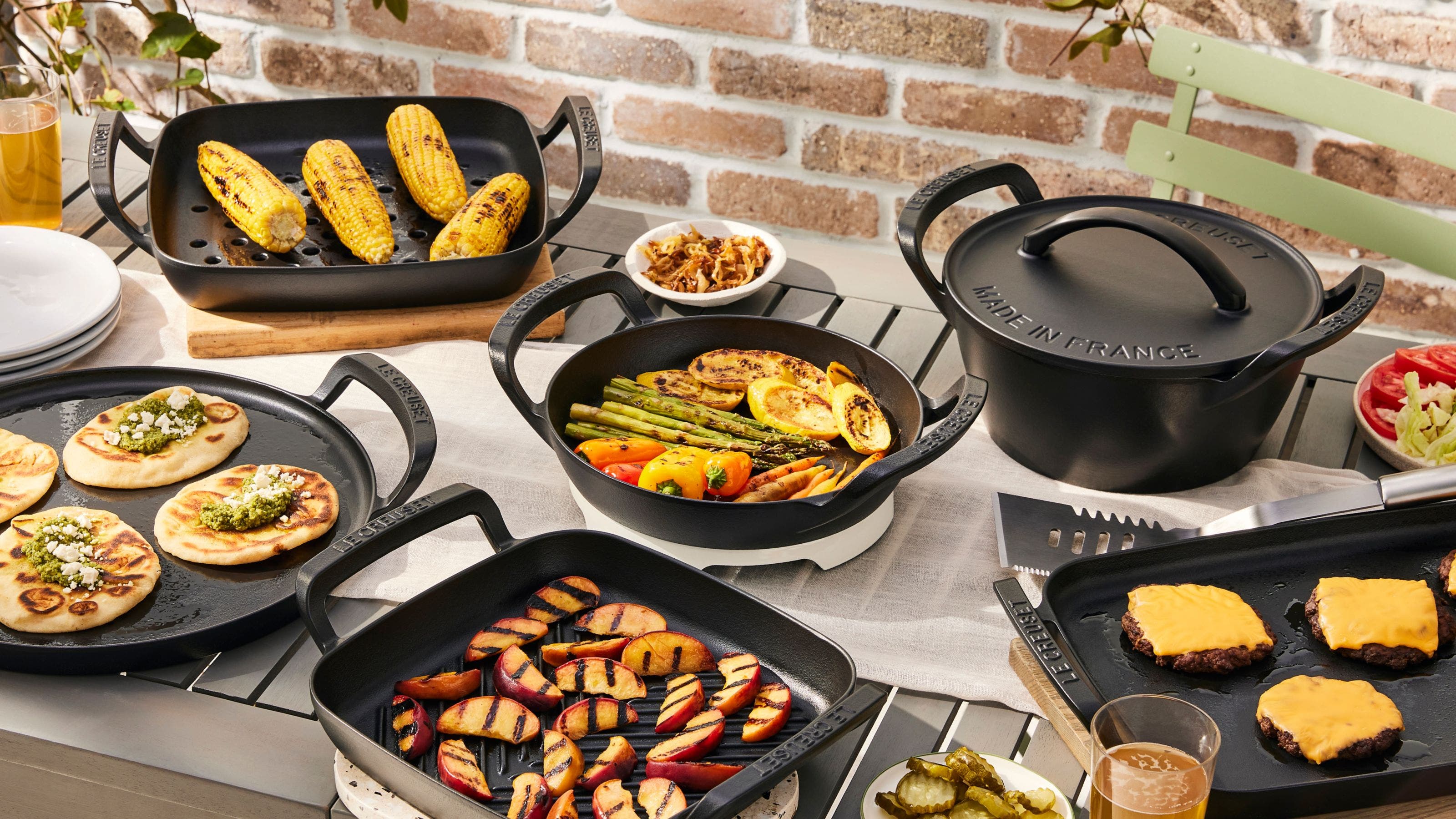 A full spread of grilled foods served on Le Crueset grill pans.