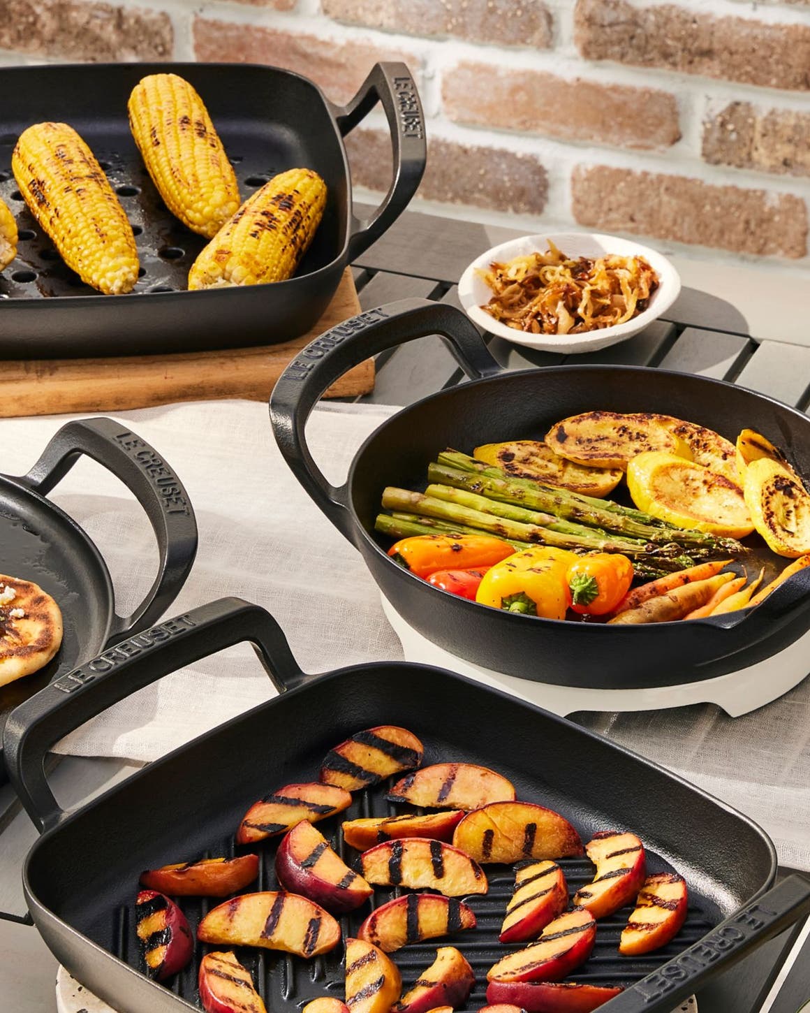 A full spread of grilled foods served on Le Crueset grill pans.